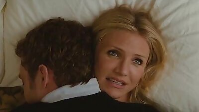 A brunette with a sexy body is performing hot things on the bed