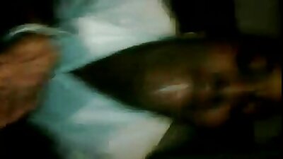 A brunette has her hair pulled while she is on top of a sofa